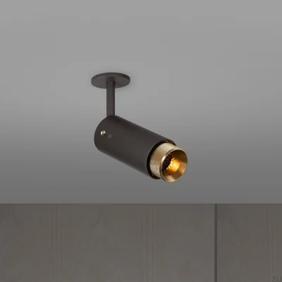 Farol auxiliar ajustável em cruzeta de escape, aço grafite com detalhes em latão.