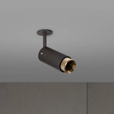 Farol auxiliar ajustável em cruzeta de escape, aço grafite com detalhes em latão.